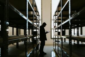 person with clipboard in warehouse