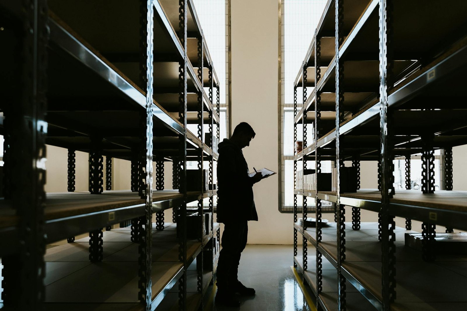 person with clipboard in warehouse